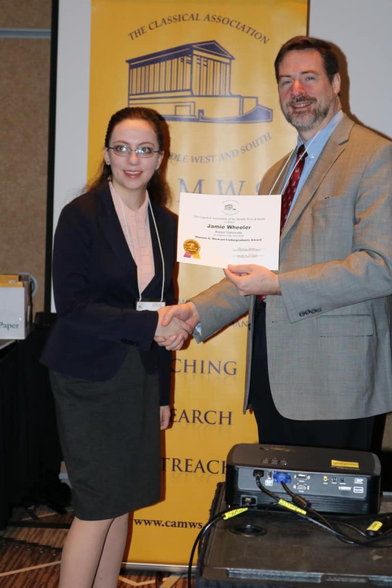 A CAMWS award recipient shaking hands with a CAMWS officer
